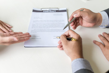 Business people, signing a contract, meeting together at a meeting.