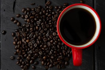 dark coffee in red cup on wooden table