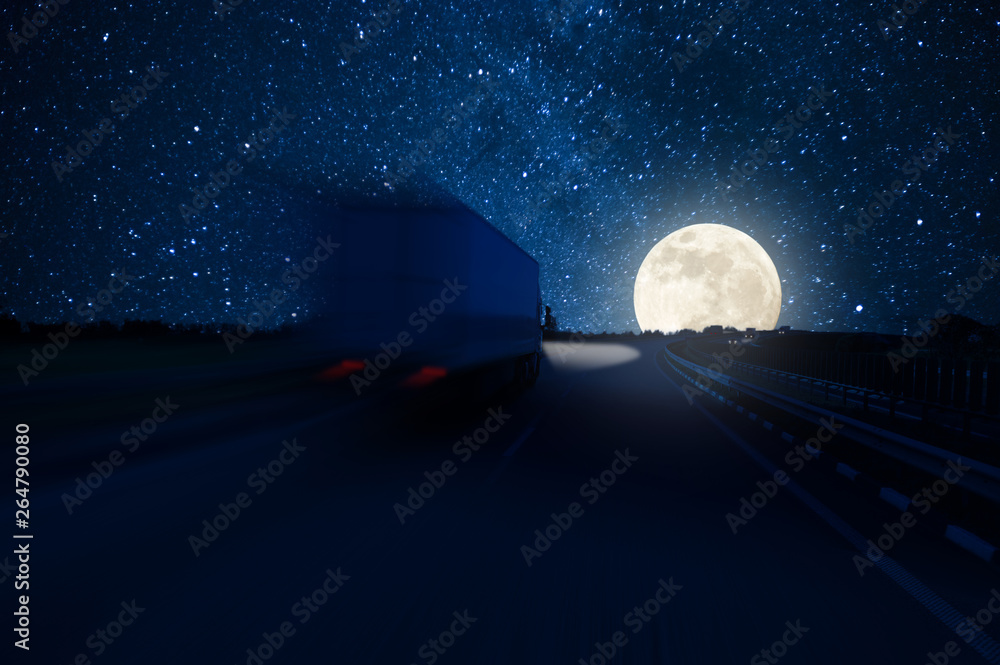 Wall mural Track in motion blur on highway, fast delivery anywhere in the world, night road with moon and stars in sky