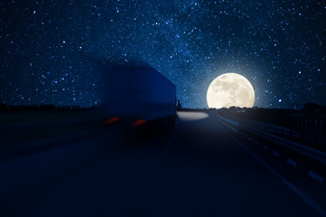 Track in motion blur on highway, fast delivery anywhere in the world, night road with moon and...