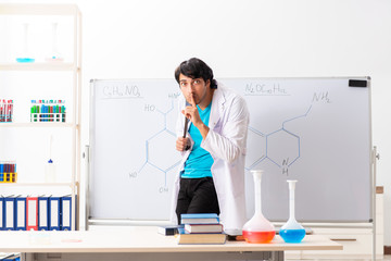 Young student chemist in the classroom 