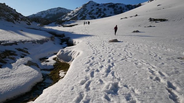 Matese Lake, Campania, Italy - february 2 2019: snowshoeing on snow covered plateau with blue sky. Matese Mounts landscape, Campo dell'esule (Field of the exile), Campo dell'arco (field of the arch)