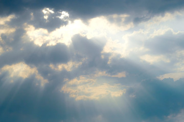 Rain clouds and bright rays splash through the rain clouds.