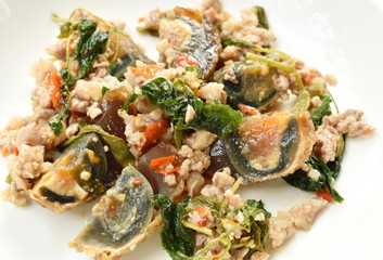 stir fried crispy basil leaf with black preserved egg and minced pork on dish