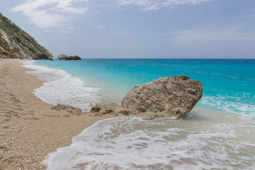 Beach in Lefkada, Greece in the afternoon with cyan blue water