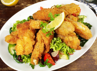 Backhendl Platte mit Zitrone auf Salat