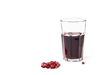 Pomegranate juice in a glass with pomegranate fruit on a white background