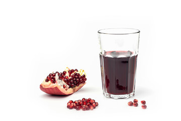 Pomegranate juice in a glass with pomegranate fruit on a white background