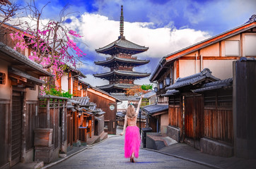 Asian woman walking Yasaka in street near Pagoda in Kyoto, Japan.