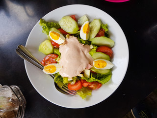 Chef's salad egg lettuce tomatoe cheese in a plate