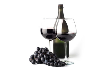 Red wine in a glass with a bottle and grapes on a white background