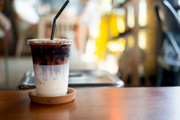 Iced coffee or latte macchiato in plastic glass