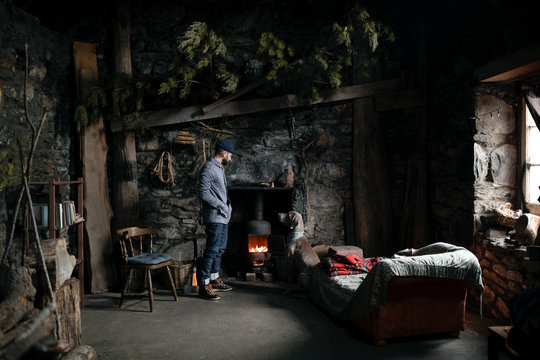 Man and a dog in front of the fire