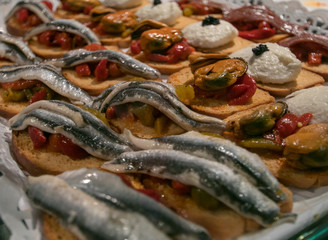 Pintxos, Brushetta, tapas, spanish canapes seafood, mussels, sardines and cod in San Miguel Market Madrid
