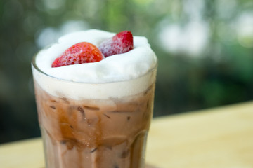 Chocolate drink with freeze strawberry put on milk foam