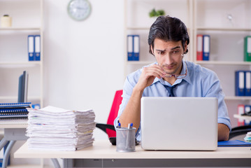 Young male businessman employee unhappy with excessive work  