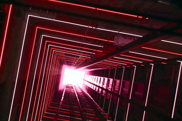 Elevator corridor in the building lit by red elumination. Futuristic elevator shaft is located in a high tower. Lift shaft in a residential building. Abstract, background. Bottom view. © polack