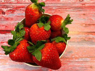 Fresh, juicy strawberries on wooden background.
