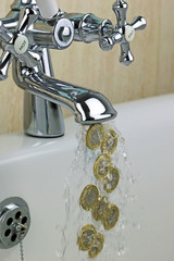 Pound Coins Flowing From A Tap. Concept On The Rising Costs Of Water Utilities