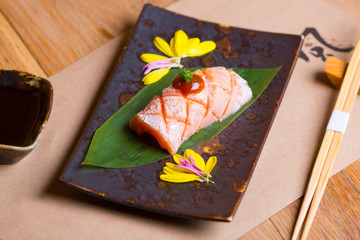 sushi on plate with chopsticks