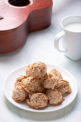 cookies on a plate with cup of tea