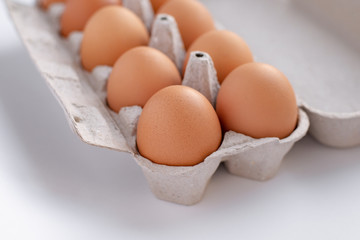 chicken brown eggs in a tray, close