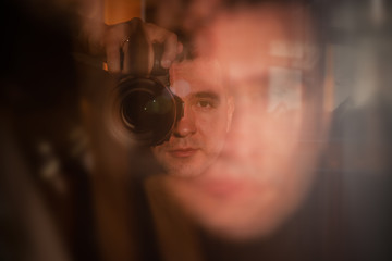 Blurred photo young attractive caucasian man photographer journalist reporter operator making...