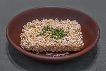 instant noodles in a brown plate