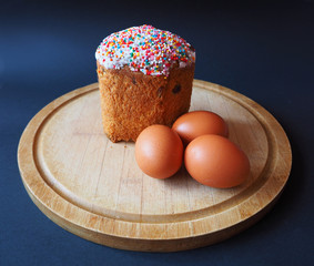 An easter cake with eggs on the wooden board