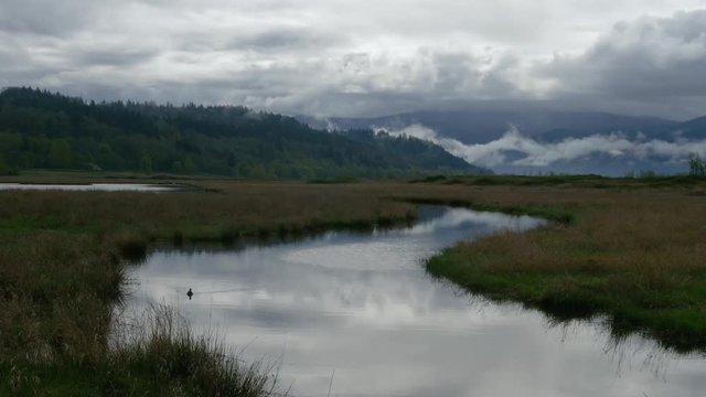 Timelapse of winding river on a dramatic cloudy day