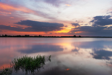Fototapeta na wymiar Beautiful evening and sunset on a wide river