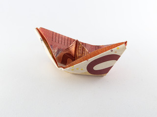 single origami boat made of ten euro note isolated on white background