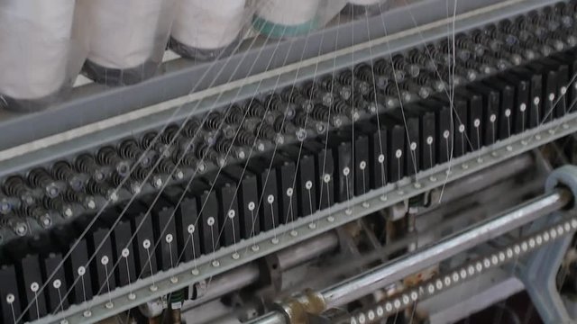 Automatic loom in mattress factory. Tilt up shot
