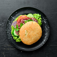 Burger with salami, tomato and onions. Breakfast. Top view. Free space for your text.