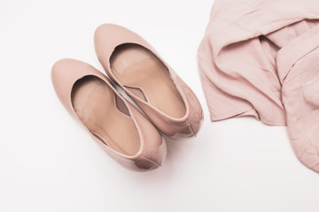 Fashionable concept, pastel beige shoes with high hills and delicate blouse on white background, sale, diascount and shopping concept