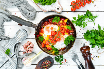 Shakshuka Eggs with tomatoes and vegetables in a frying pan. Breakfast. Top view. Free space for your text.