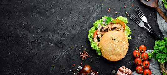 Vegetarian burger with mushrooms and vegetables. Breakfast. Top view. Free space for your text.