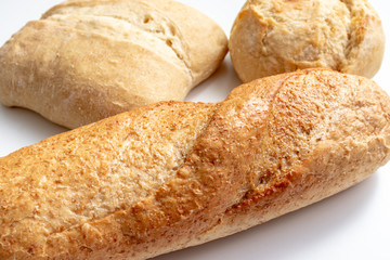 Assortment, different kind of wheat baked bread with golden crust on the table