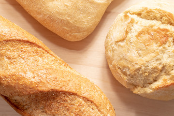 Assortment, different kind of wheat baked bread with golden crust on the table