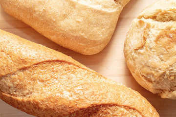 Assortment, different kind of wheat baked bread with golden crust on the table