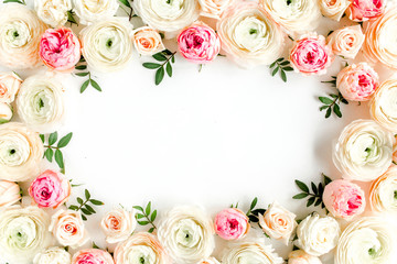 Floral pattern frame made of pink ranunculus and roses flower buds on white background.  Flat lay,...