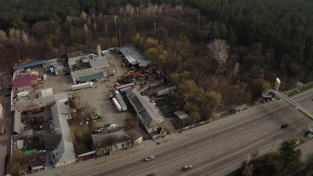 Aerial time lapse of junkyards next to the highway.