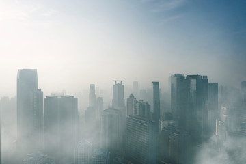 Fototapeta na wymiar Misty skyscrapers in Jakarta downtown at morning