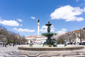 Fototapeta na wymiar Lisbon, Portugal - may 13, 2018: The Praça Dom Pedro IV square or Rossio square in the city centre of Lisbon with fountain and monument of Pedro IV, known as “the Soldier King”