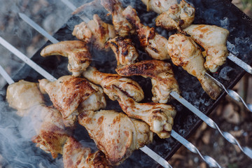 Closeup photo of preparation barbecue grill with chicken meat on outdoor in time summer. Cooking food in nature
