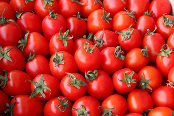 Background of many of juicy ripe red tomatoes