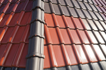 Roof covered with tiles in different colors. Roofing.