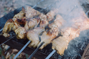 Closeup photo of preparation barbecue grill with chicken meat on outdoor in time summer. Cooking food in nature