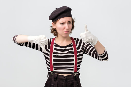 mime making good or bad sign showing thumb up making a choice.