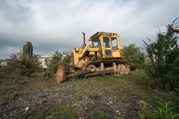Fototapeta na wymiar Old rusty yellow caterpillar bulldozer